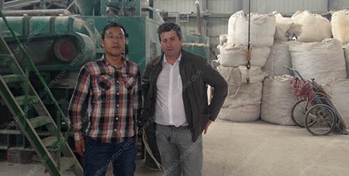 take photo with customer in front of the briquette machine in fluorite briquette plant