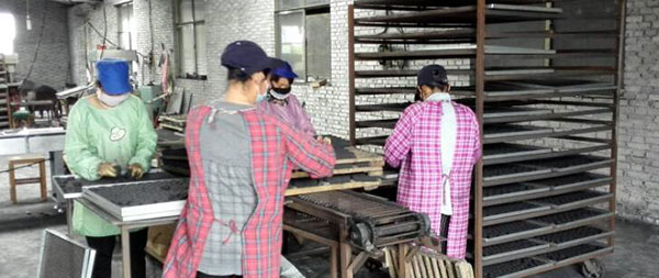 workers prepare the charcoal for drying